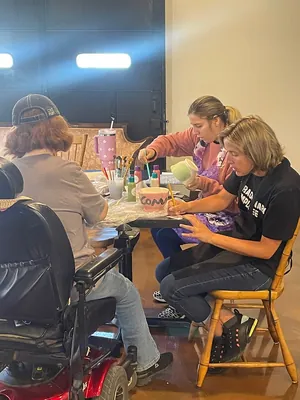 Common Grounds staff painting bowls for a local collaboration with The Pottery Place in Crossville