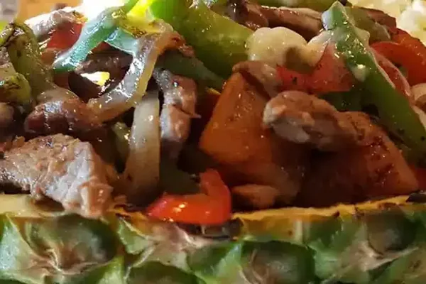 Grilled chicken and vegetables in a pineapple bowl from Casa Grande’s restaurant photo gallery
