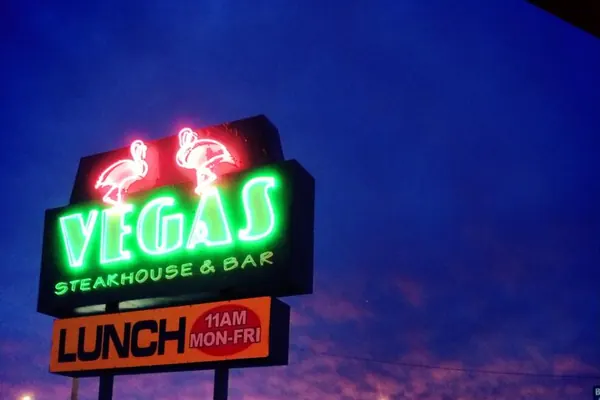 Vegas Steakhouse and Lounge sign illuminated at dusk in Crossville