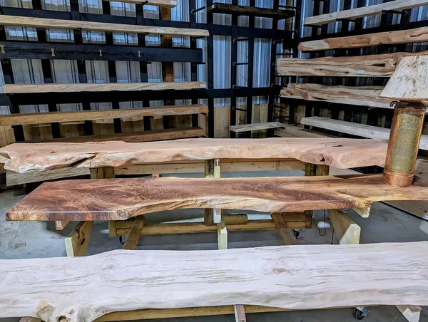 Live-edge wood slabs displayed inside Turn and Burn in Crossville