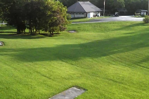 Grassy grounds and campground buildings at Ballyhoo Family Campground