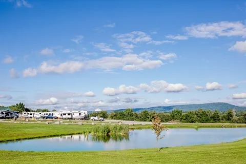 Pond and RV sites beneath the open sky at Crossville / I-40 KOA Holiday